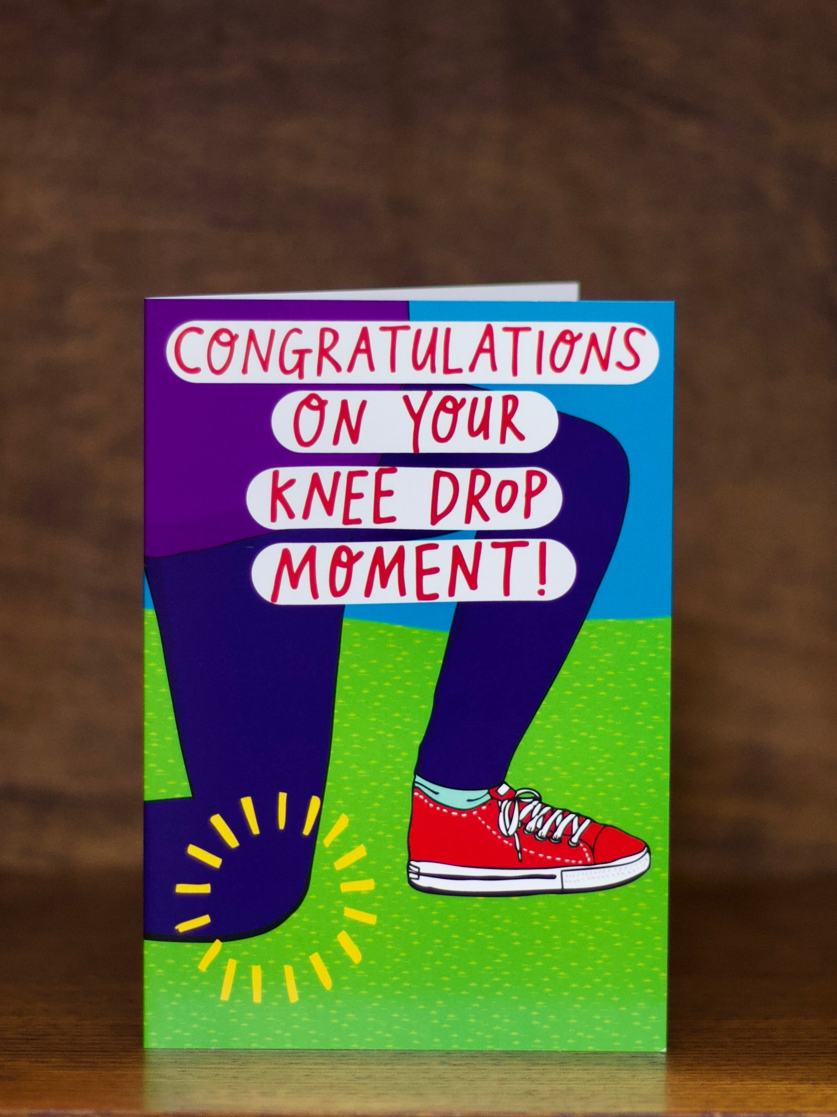 Wedding & Engagement greeting card with text 'Congratulations on your knee drop moment!' on a brown background