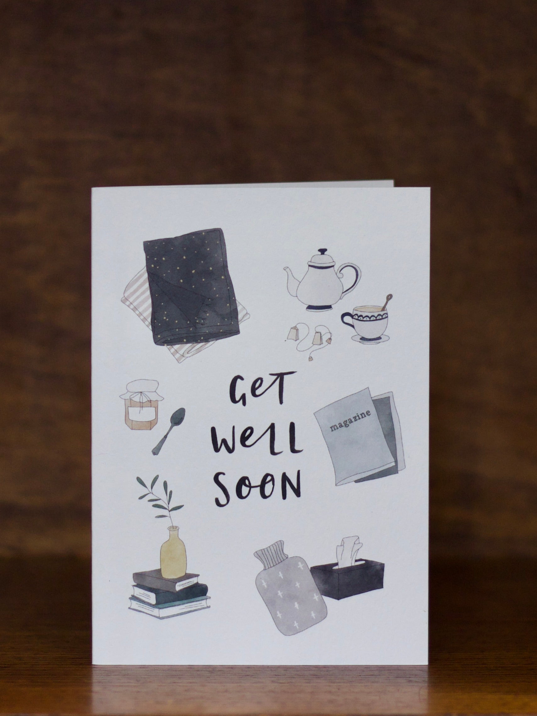 Get Well Soon greeting card with illustrations and 'Get Well Soon' text on a white background