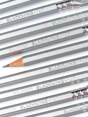Close-up of Blackwing pencils with metallic ferrules and wooden tips.