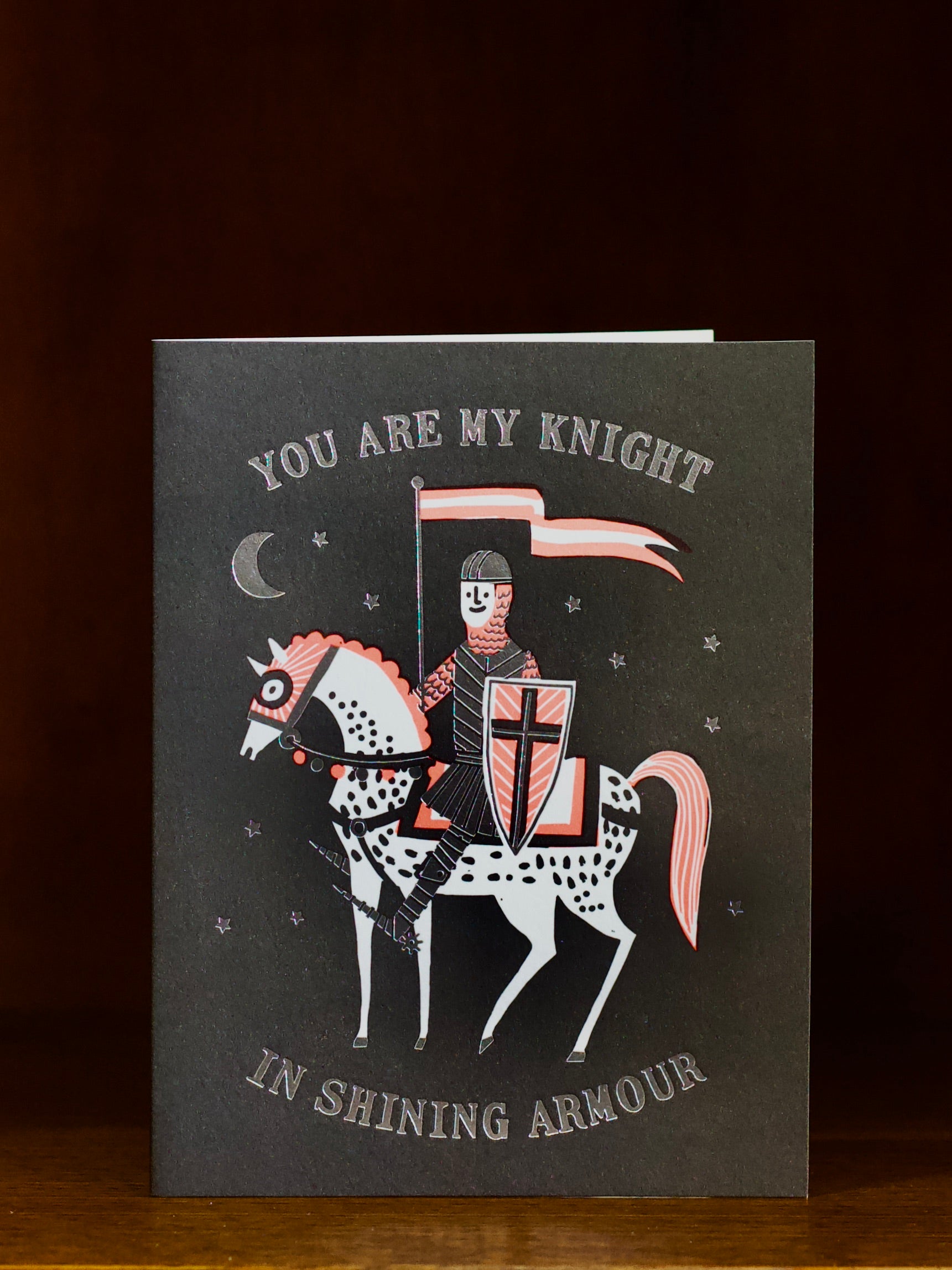 Greeting card with a knight on horseback illustration and text on a dark background