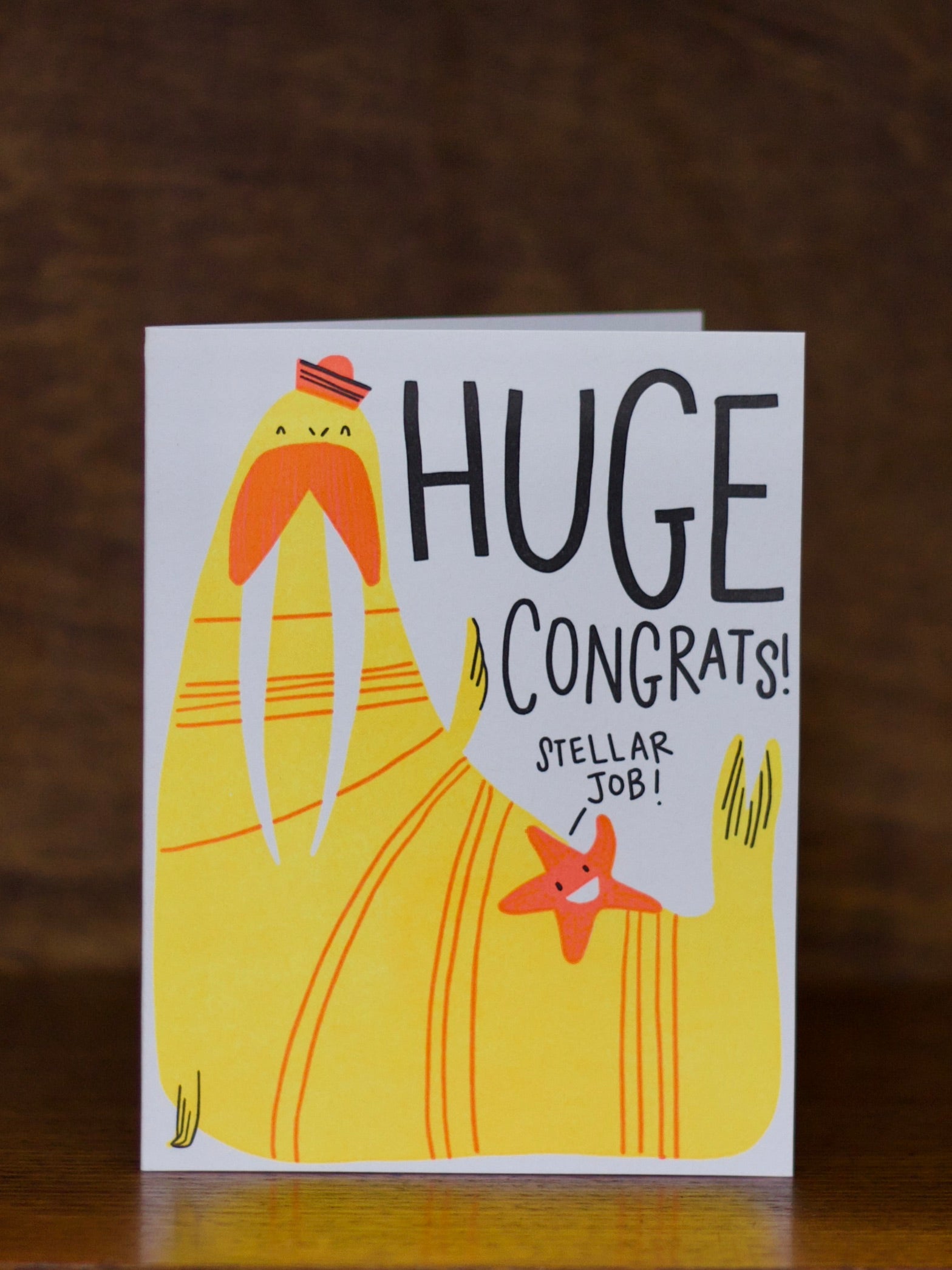 Congratulations greeting cards with a yellow character and text 'huge congrats, stellar job' on a dark background