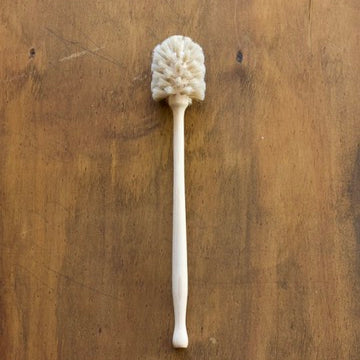 Wooden cup brush on a wooden surface