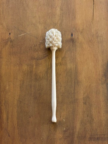 Wooden cup brush on a wooden surface