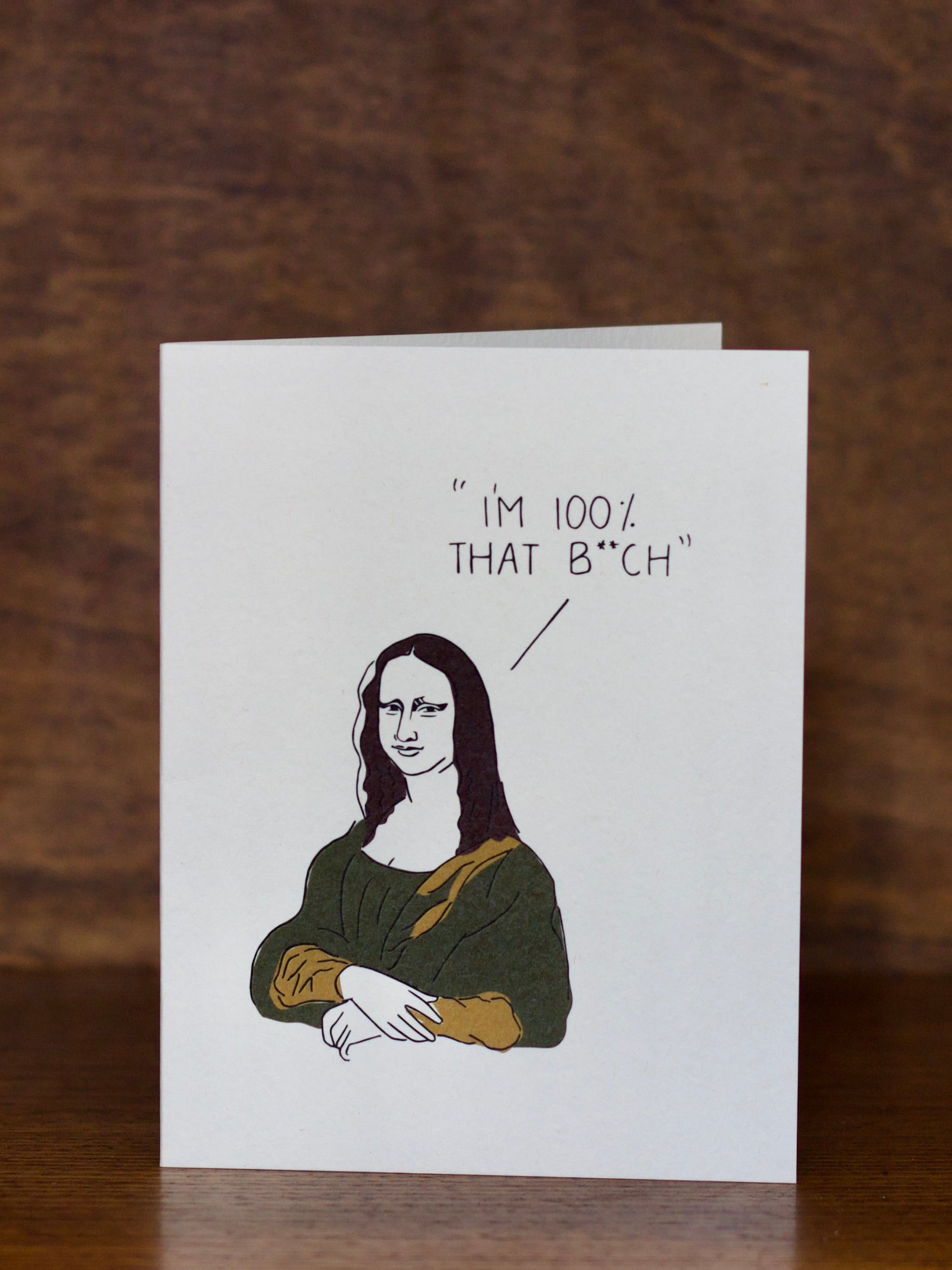All occasions greeting card with Mona Lisa graphic and text on a wooden surface