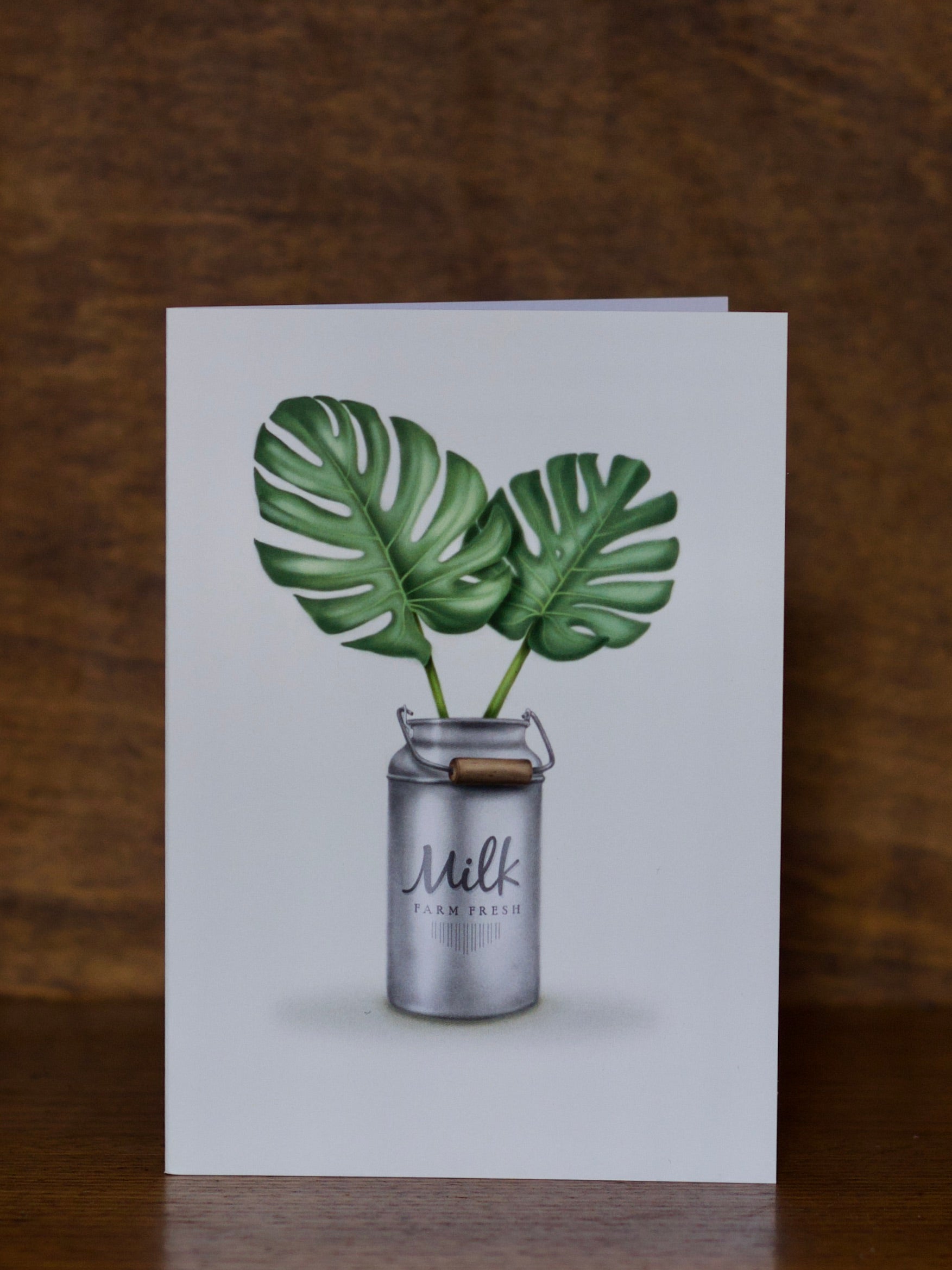 All Occasions greeting cards with a milk churn and leaves design on a wooden background