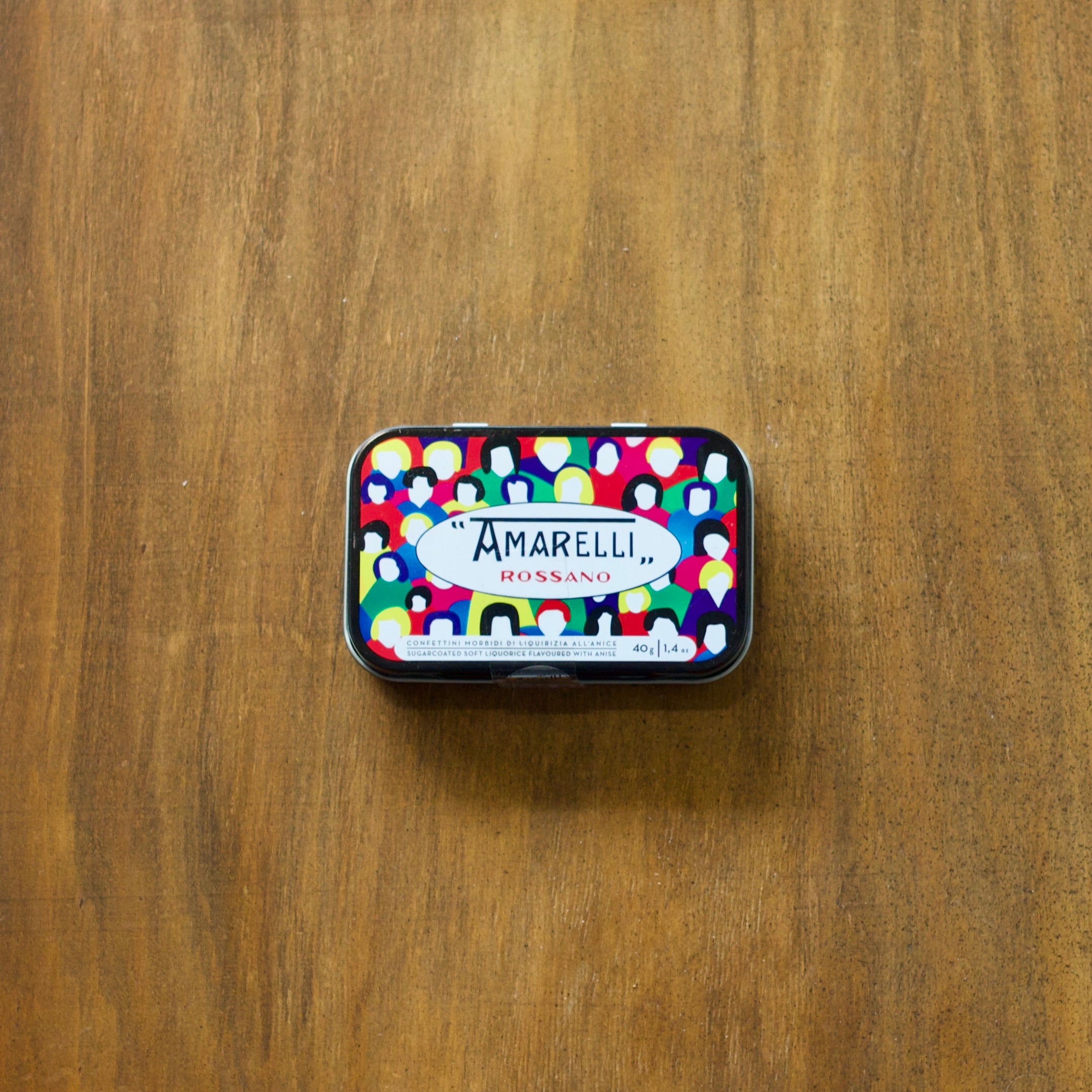 Amarelli Lodola Sugar Coated Liquorice tin with colorful design on a wooden surface