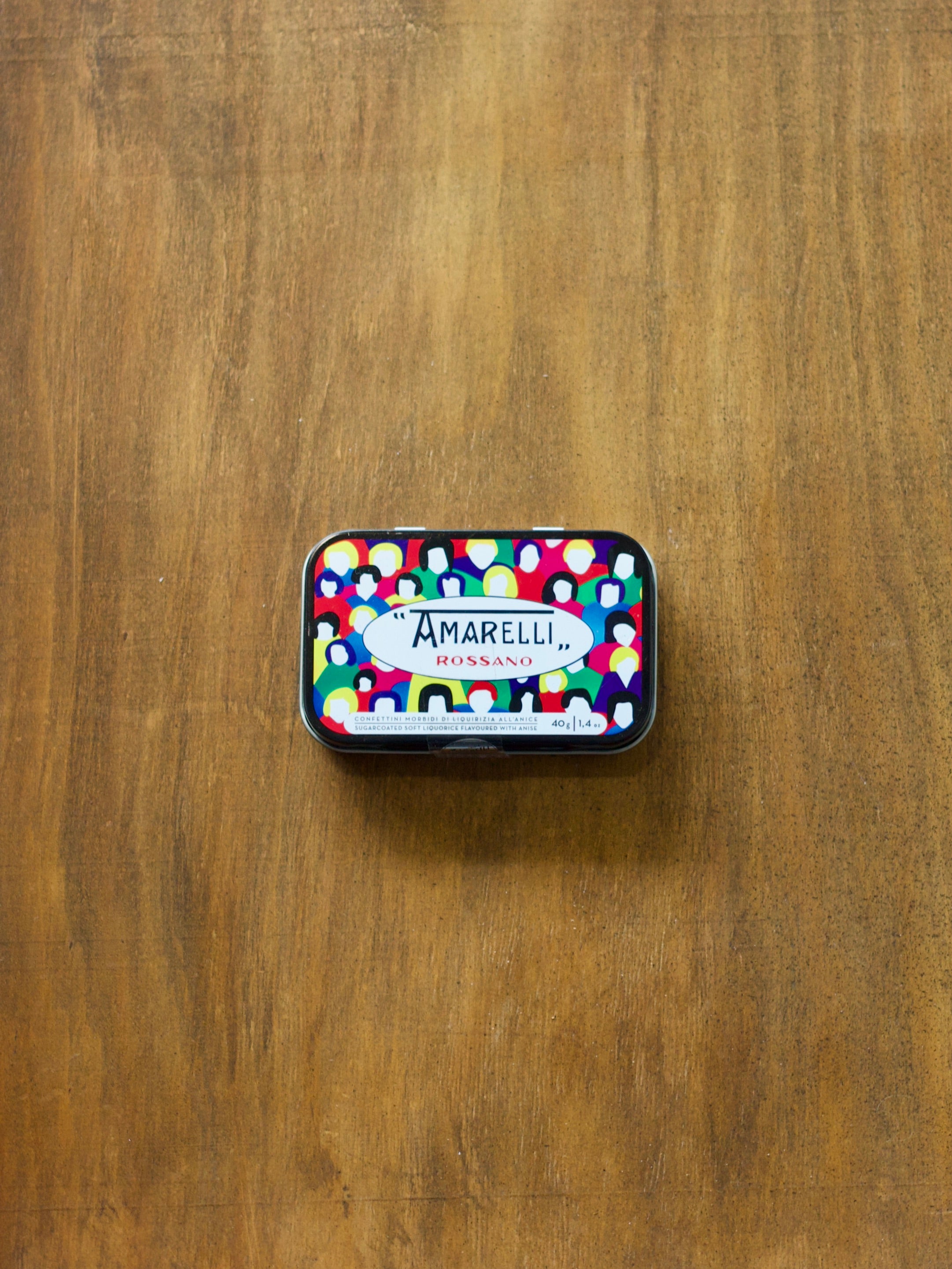 Amarelli Lodola Sugar Coated Liquorice tin with colorful design on a wooden surface