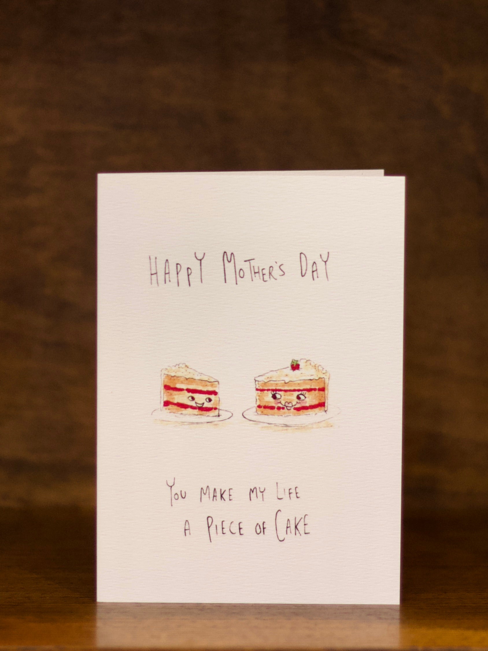 Mother's day greeting card with two cakes and text on a brown background