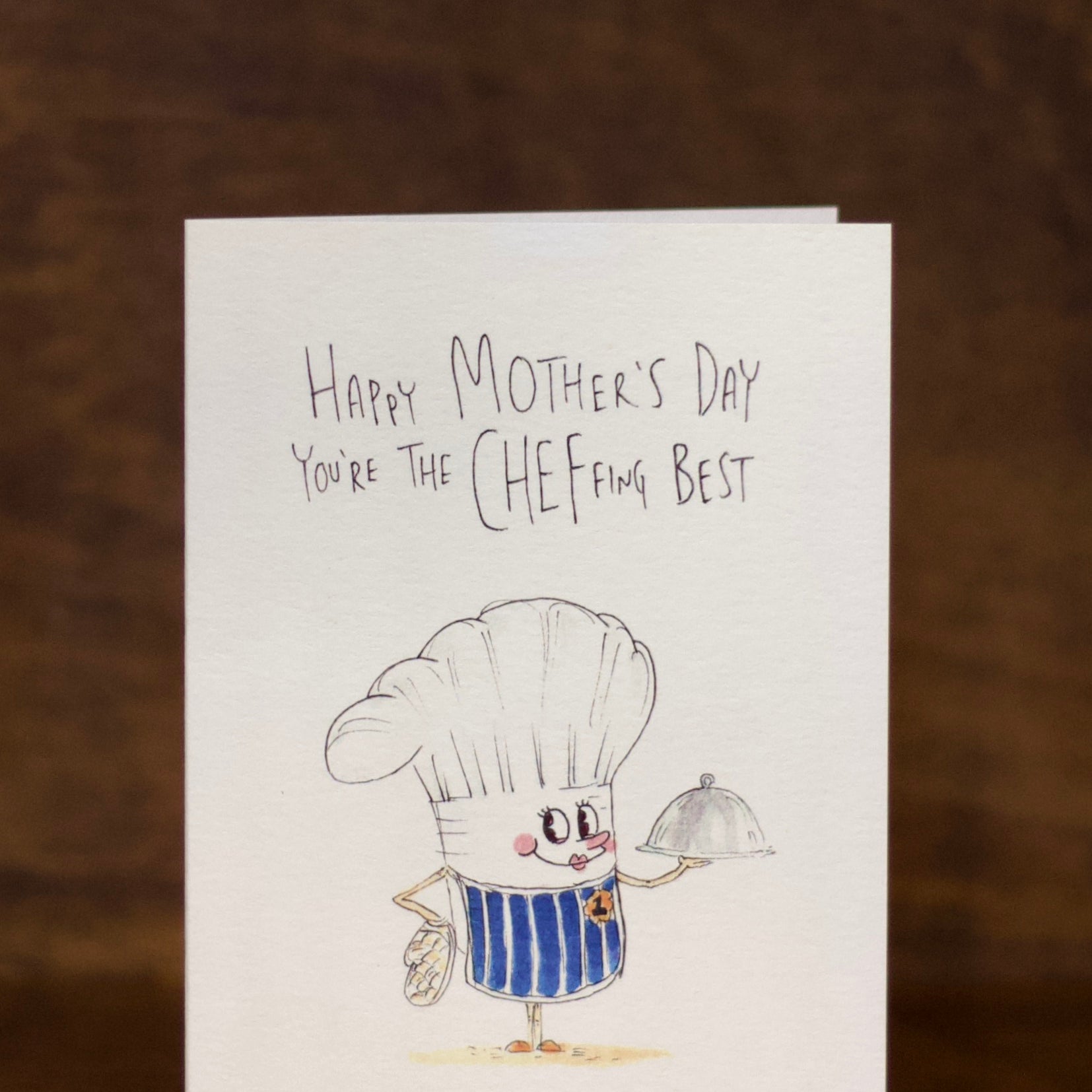 Mother's Day greeting card with a cartoon chef character on a brown background