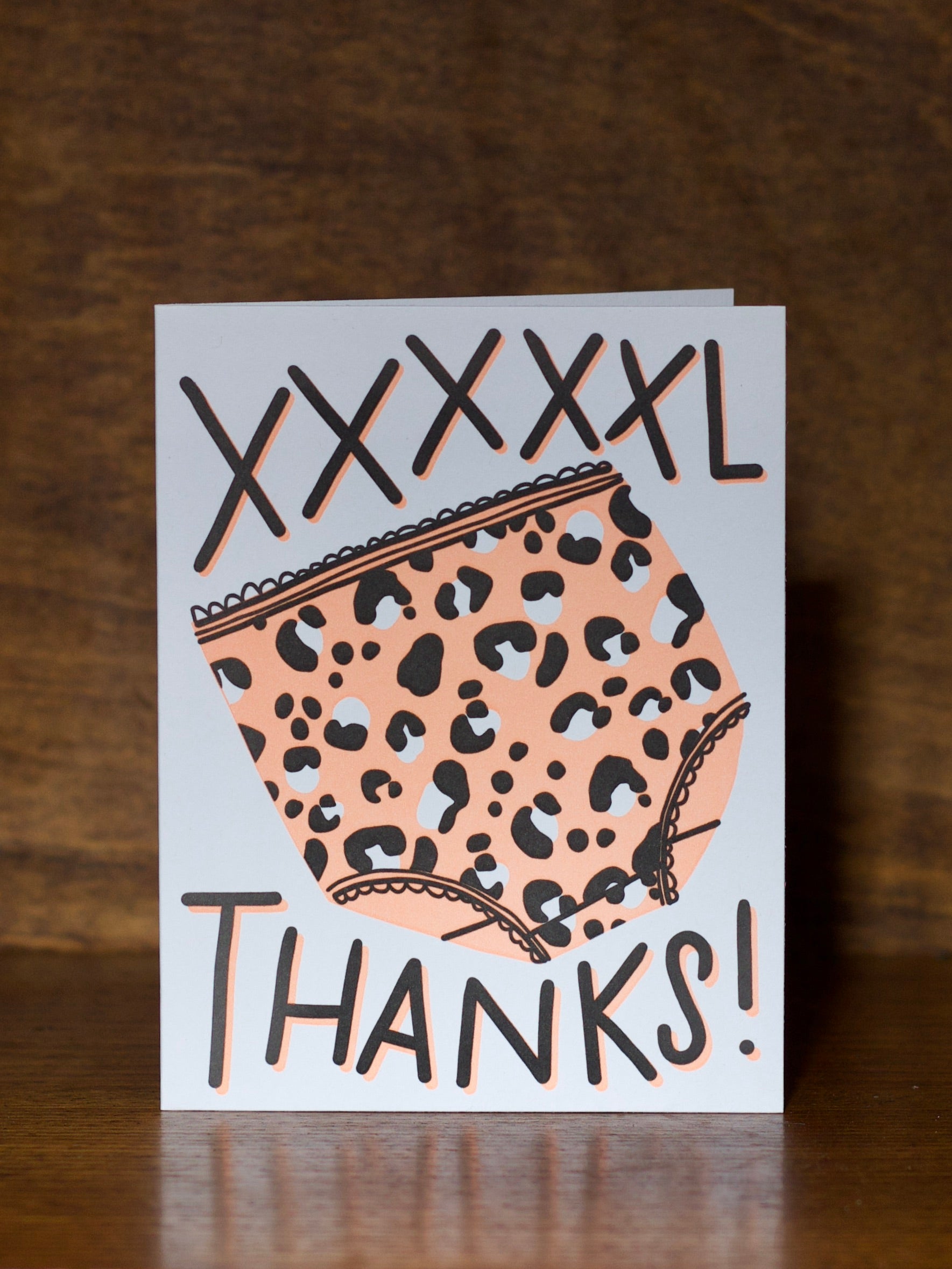 Thank you greeting cards with leopard print design and 'THANKS!' text on a wooden surface