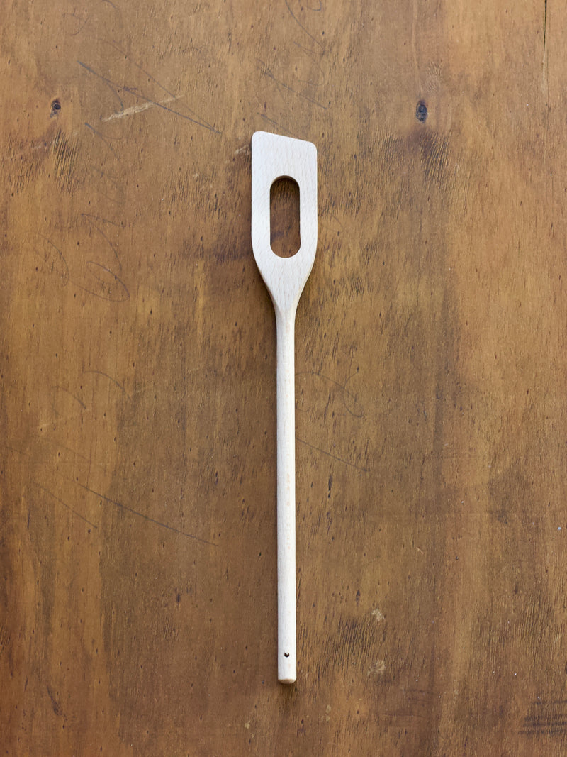 Spatula Spoon on a wooden surface.
