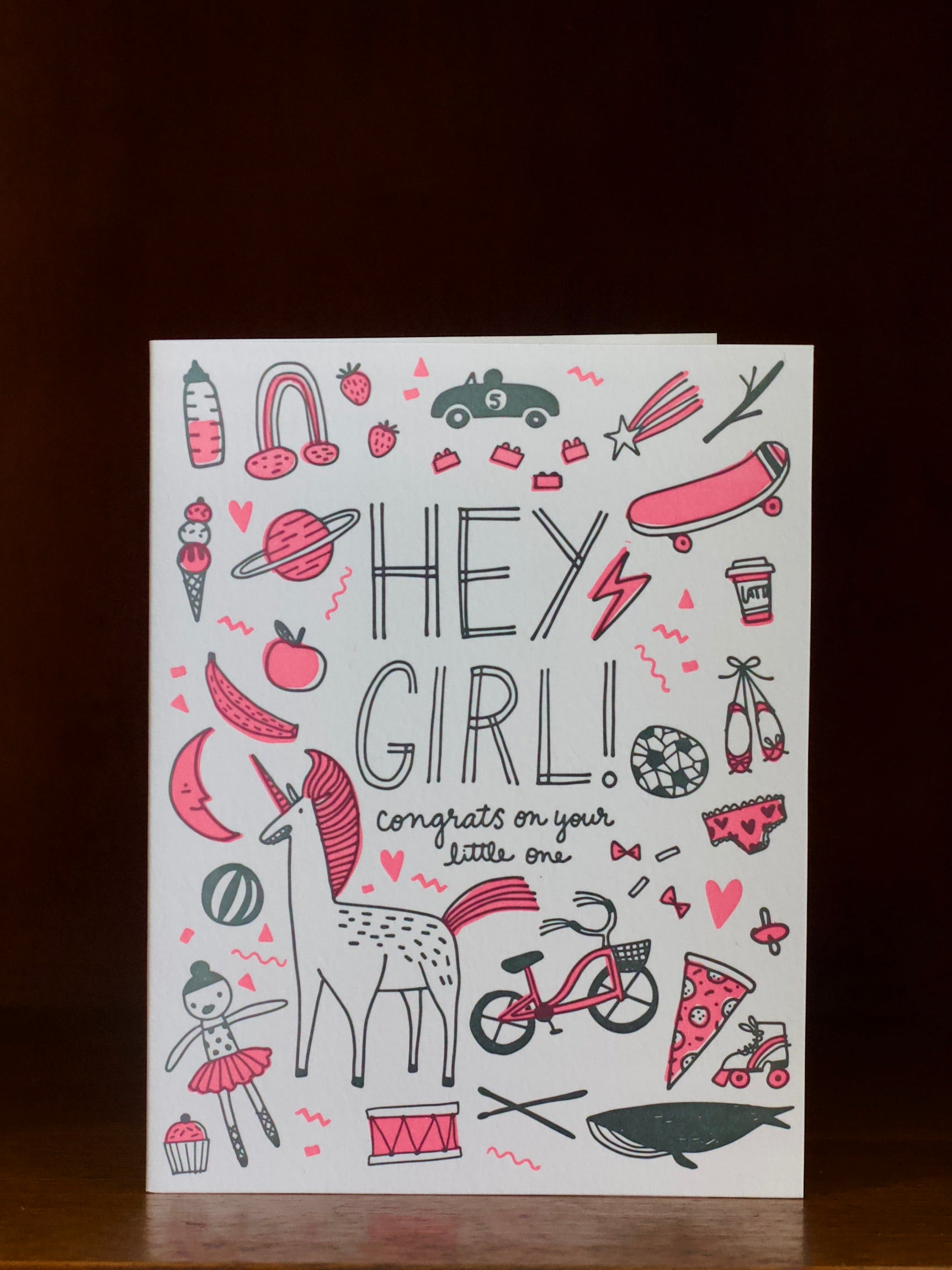 Greeting card with illustrations and text 'Hey Girl! Congrats on your little one' on a white background.