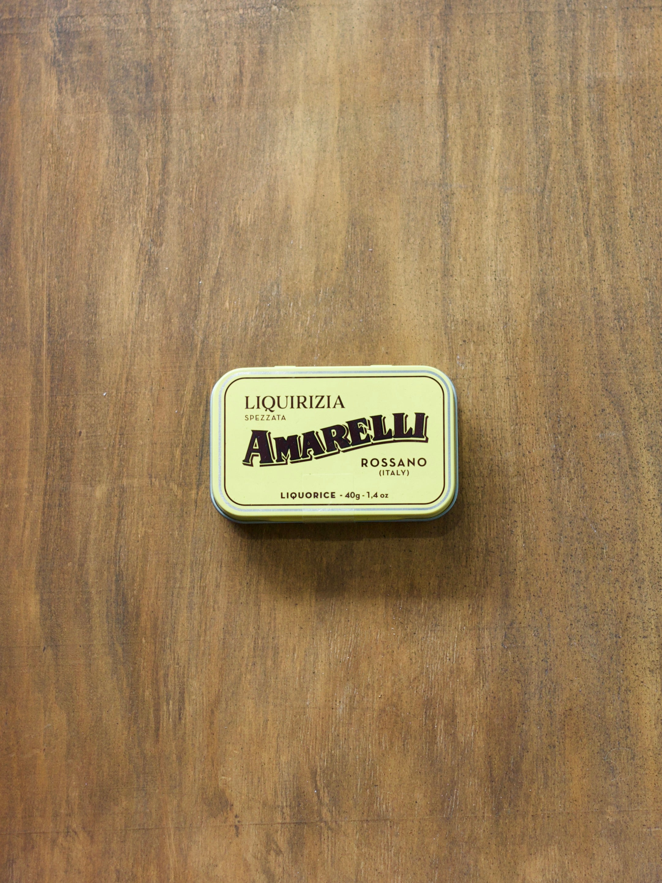 Amarelli liquorice tin on a wooden surface