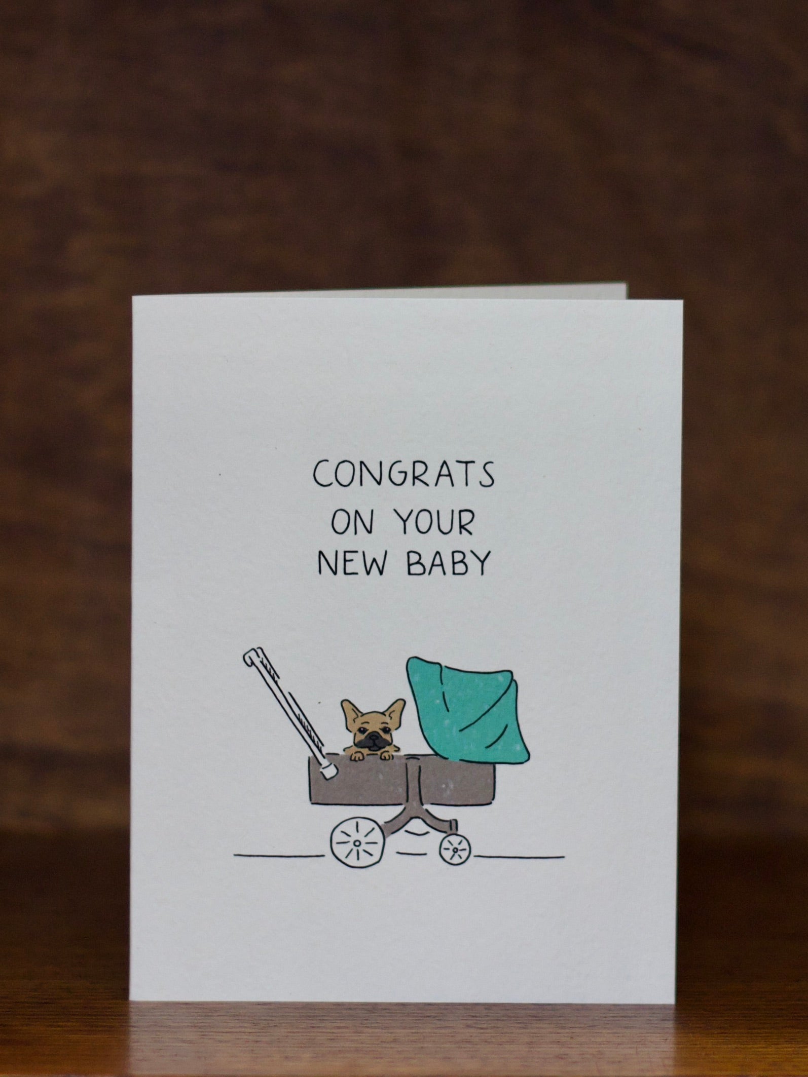 Pet congratulations greeting cards with a baby in a stroller illustration and 'Congrats on your new baby' text on a white background.