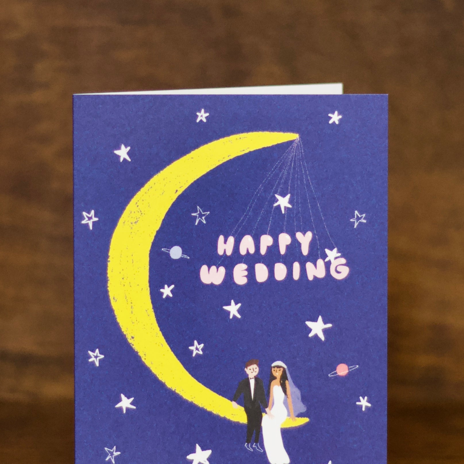 Wedding greeting cards with a crescent moon, stars, and a couple on a blue background