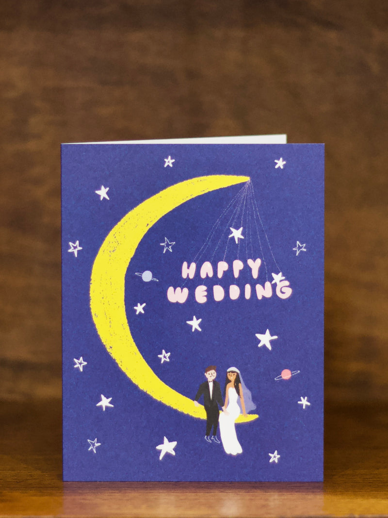 Wedding greeting cards with a crescent moon, stars, and a couple on a blue background