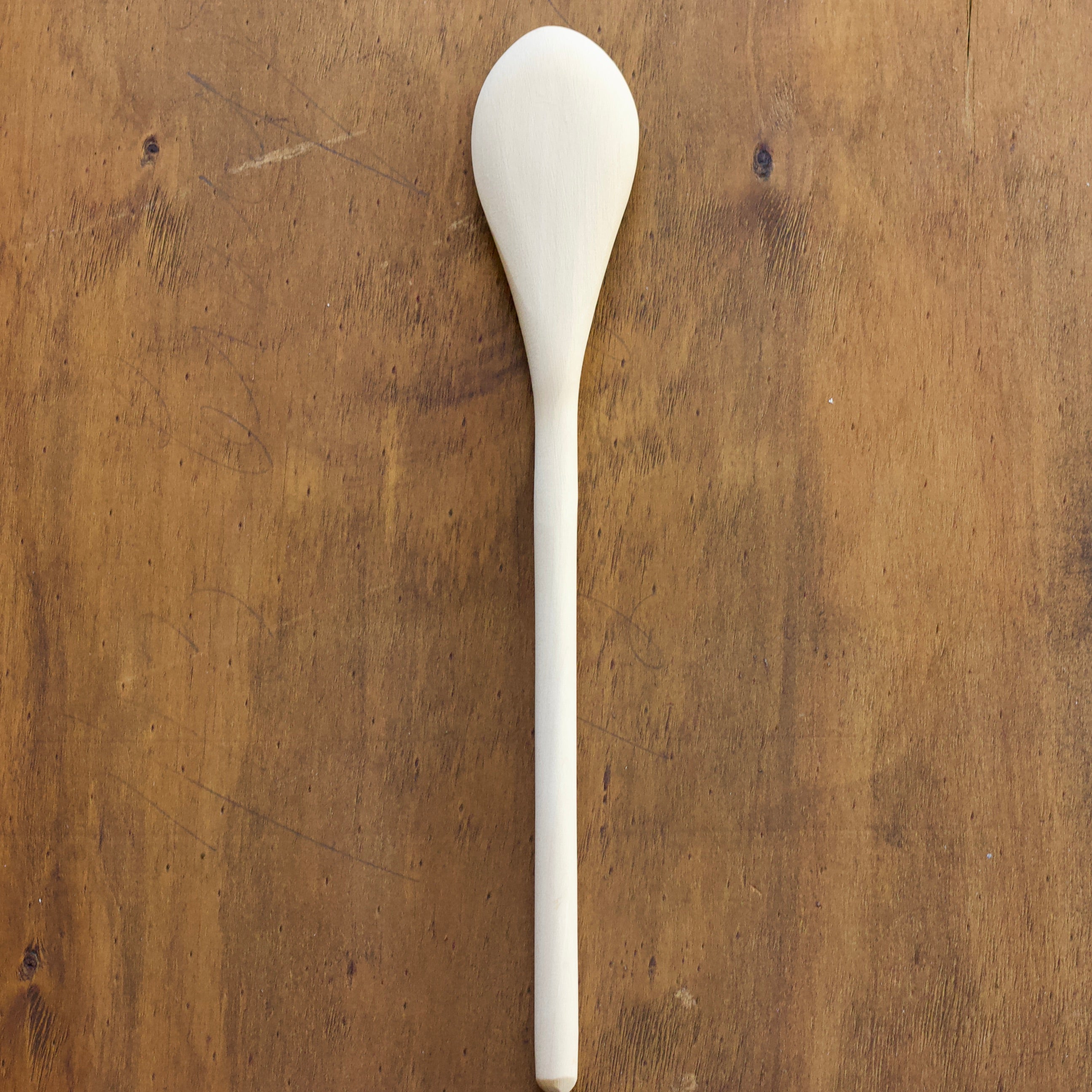 Convex Spoon on a wooden surface