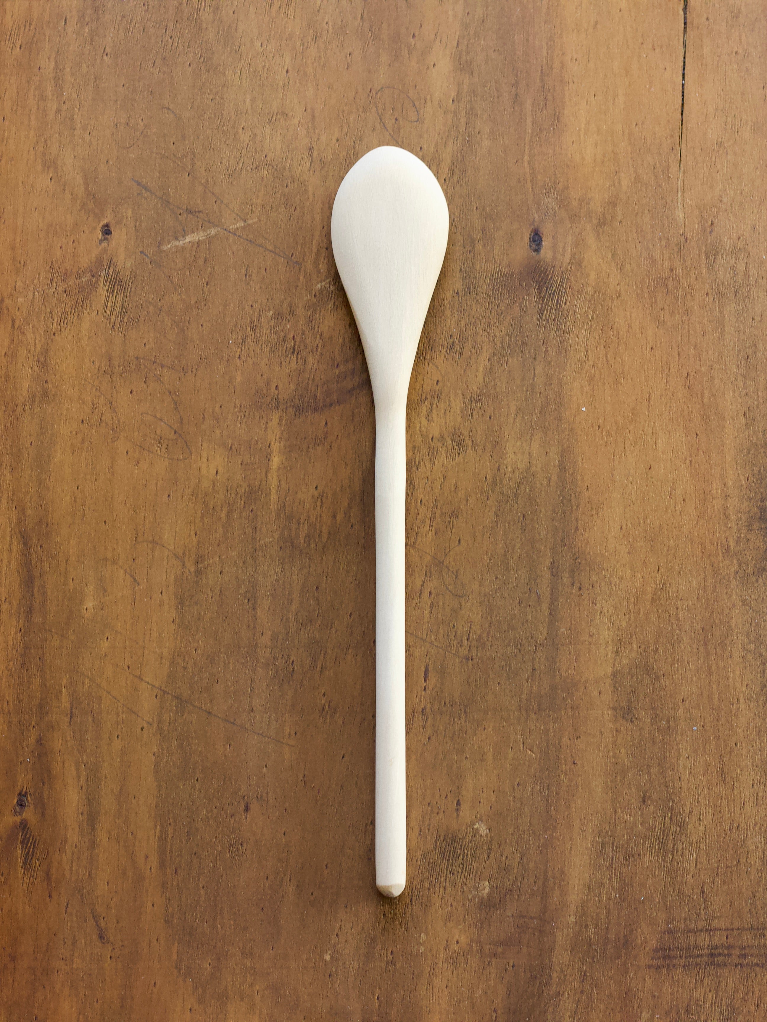 Convex Spoon on a wooden surface