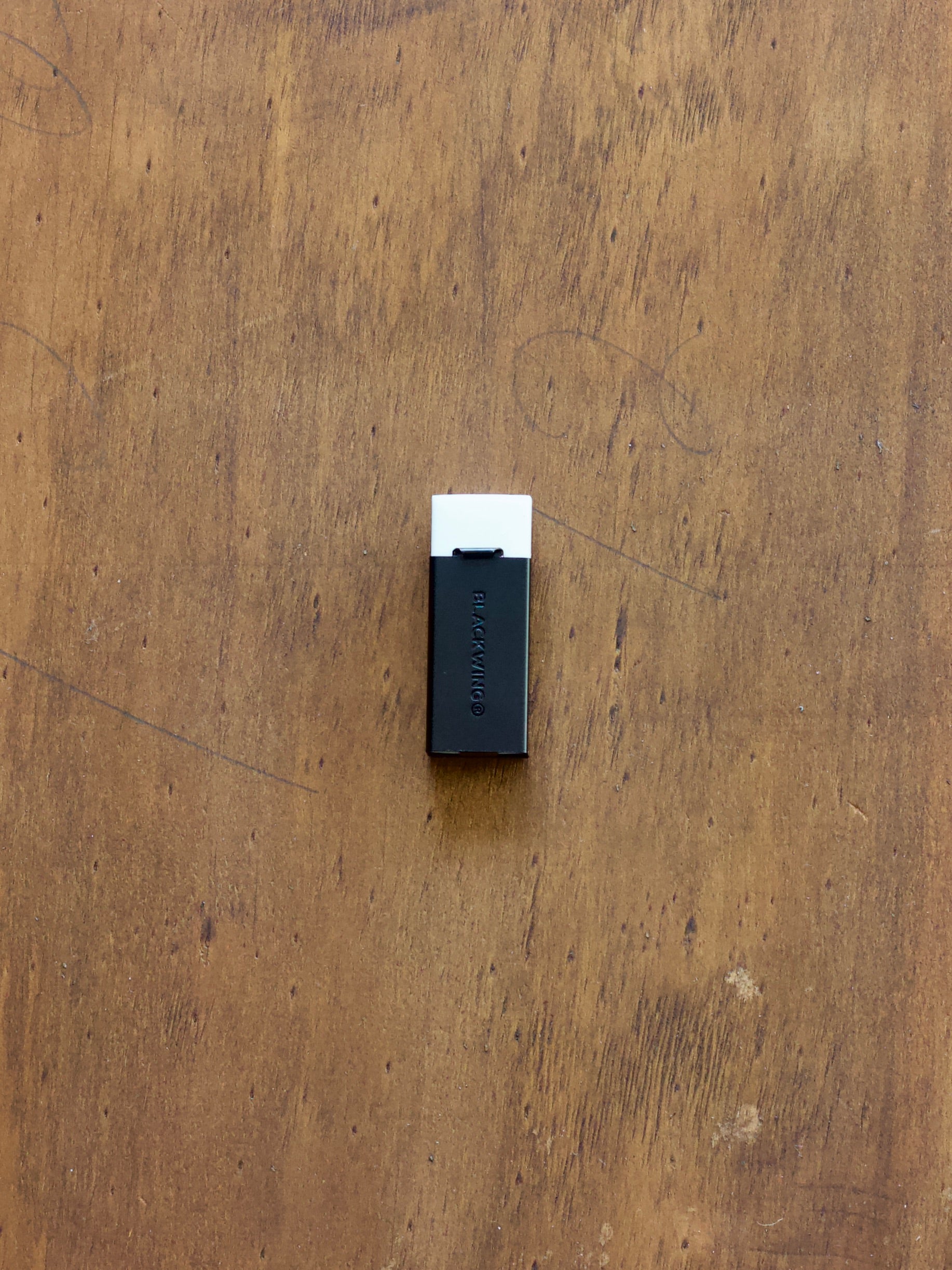 Blackwing handheld eraser on a wooden surface