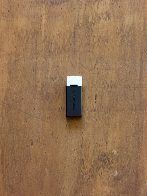 Blackwing handheld eraser on a wooden surface