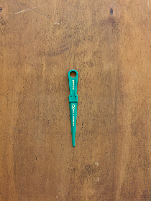 Penco Letter Opener on a wooden surface.