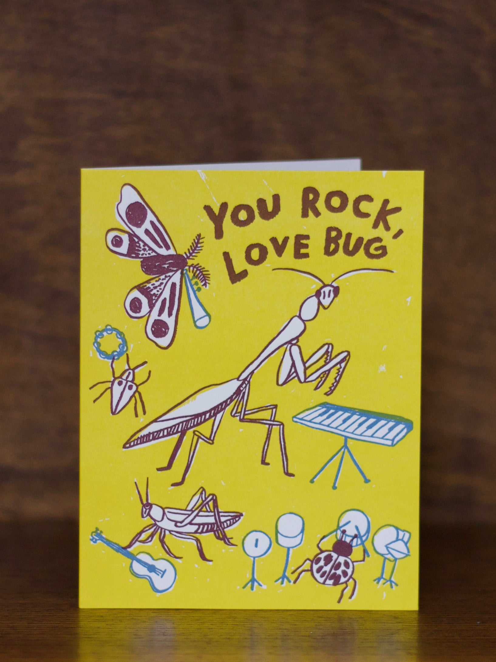 Love & Friendship greeting card with cartoon bugs and text 'You Rock, Love Bug' on a yellow background