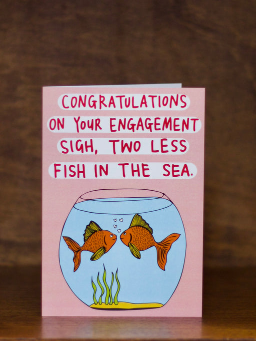 Engagement greeting card with fish illustration and humorous text on a pink background