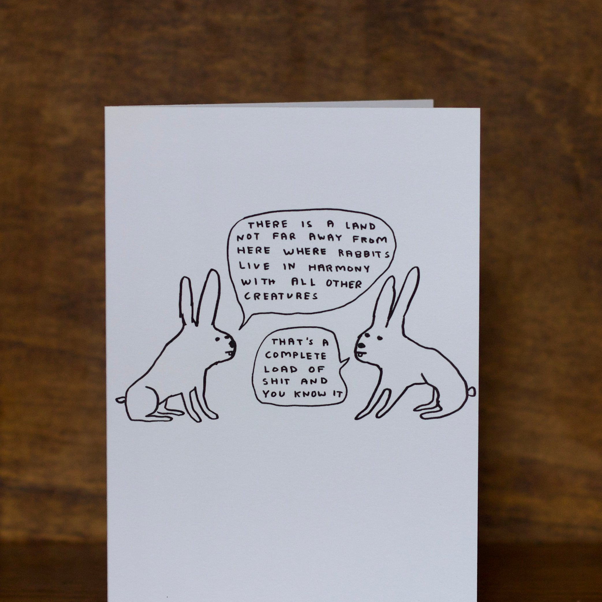 All occasions greeting card with rabbit illustration and text on a wooden surface
