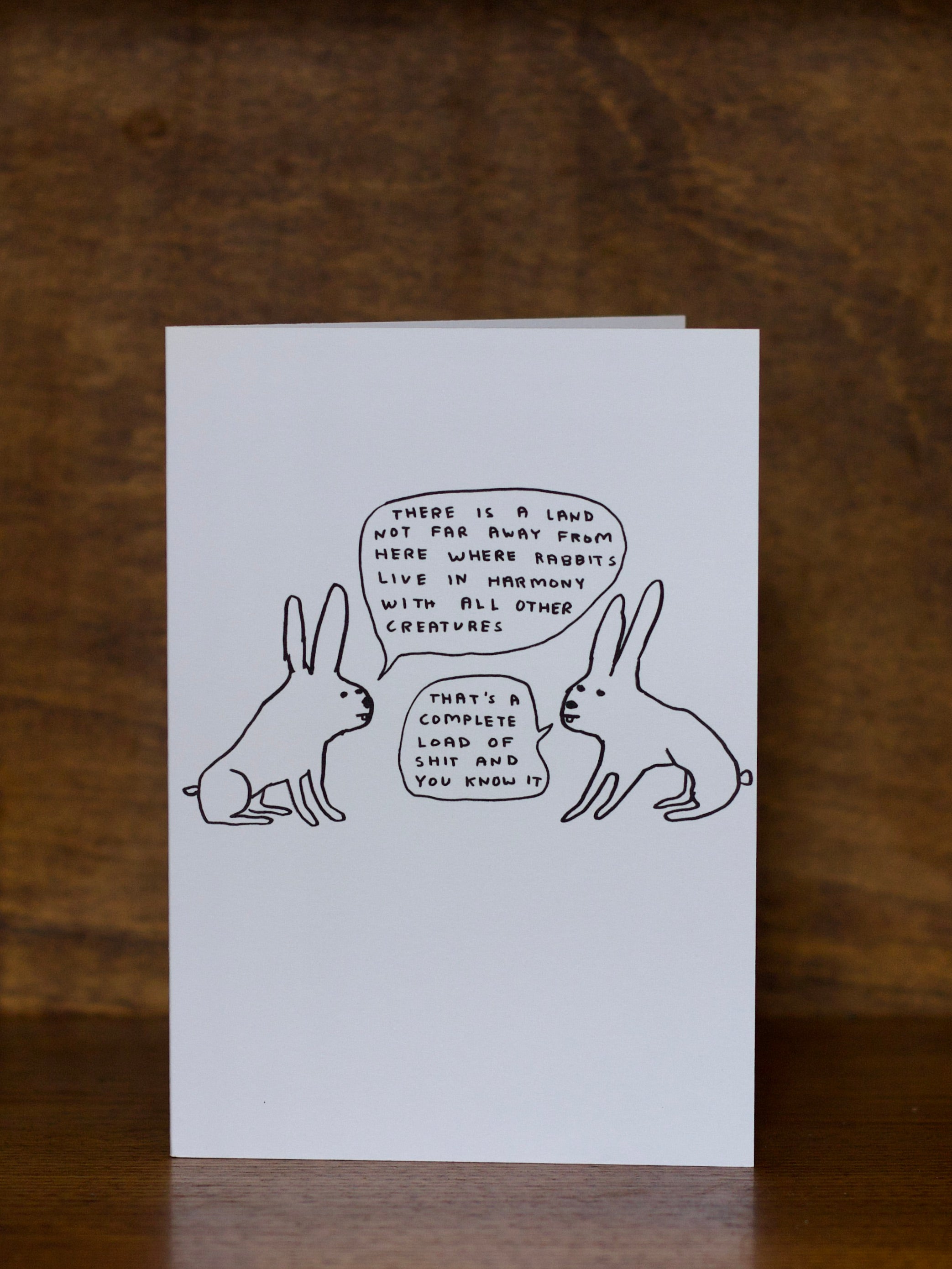 All occasions greeting card with rabbit illustration and text on a wooden surface