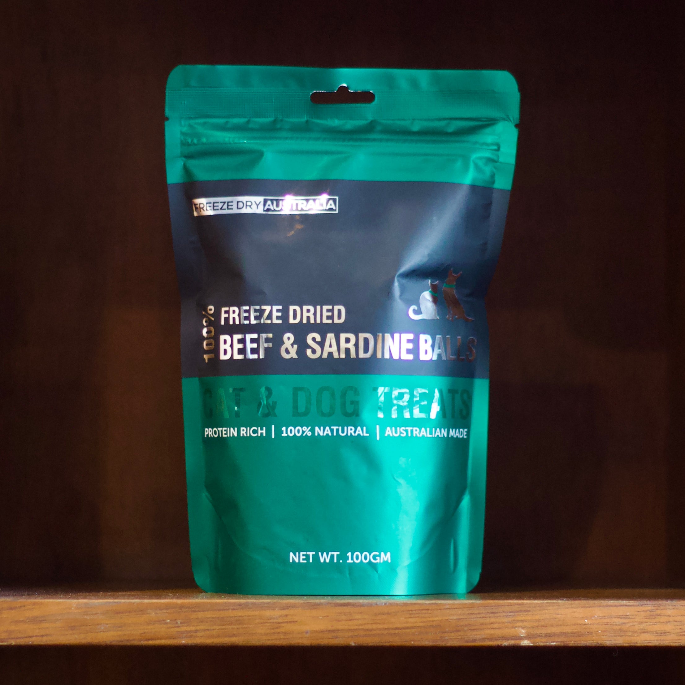 Freeze dry beef and sardine balls pet treats on a wooden shelf 