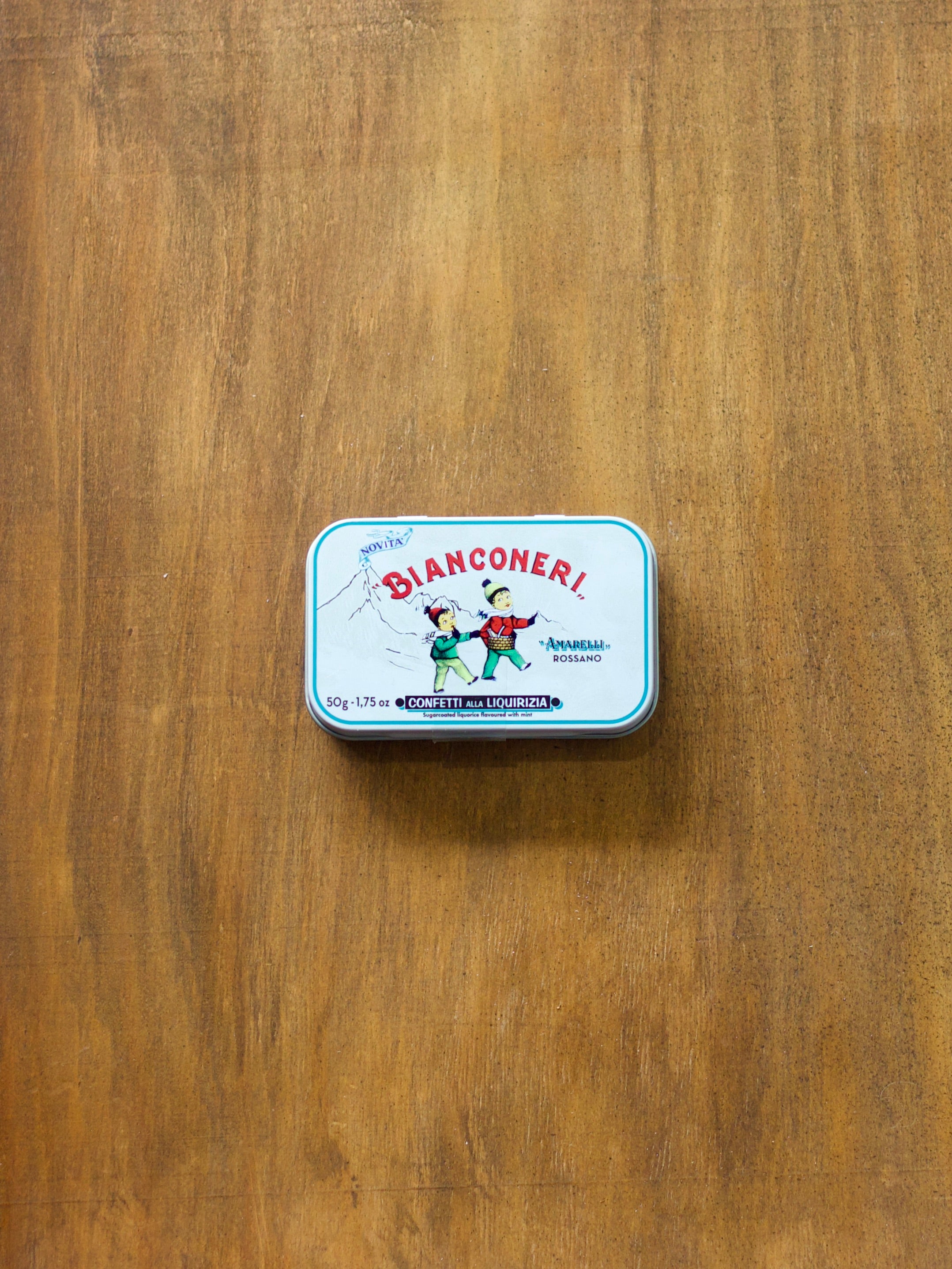 Bianconeri Sugar Coated Liquorice in a small metal tin on a wooden surface