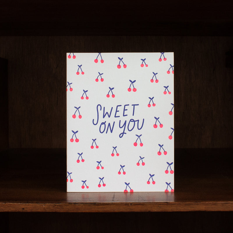 Hello Lucky greeting card with 'Sweet on You' text and cherry pattern on a wooden surface