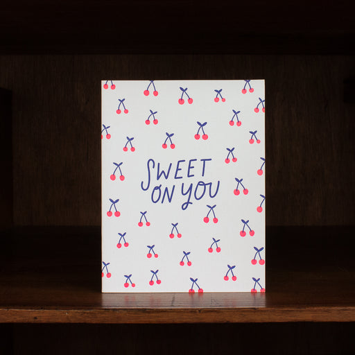 Hello Lucky greeting card with 'Sweet on You' text and cherry pattern on a wooden surface