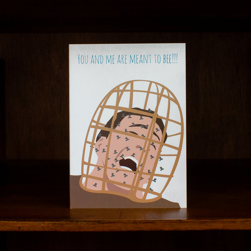 Meet me in shermer greeting card with illustration of a person in a birdcage and text 'You and me are meant to bee!!!', on a dark background.