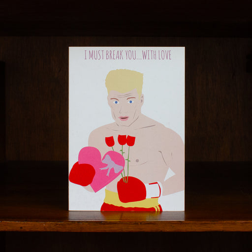 Meet me in shermer greeting card with illustration of a person holding boxing gloves and flowers on a wooden surface.