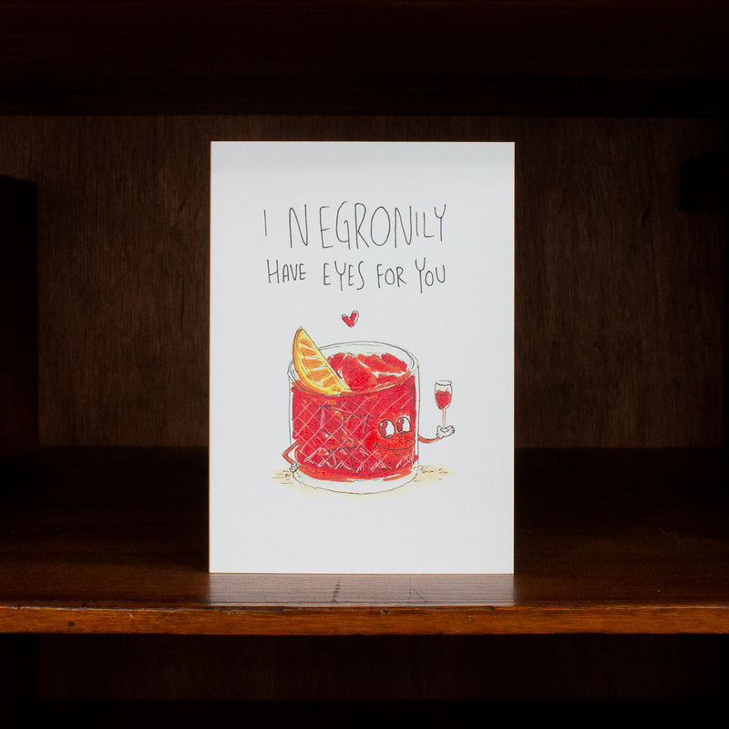 Anniversary and Love greeting card with Negroni illustration and text on a wooden surface