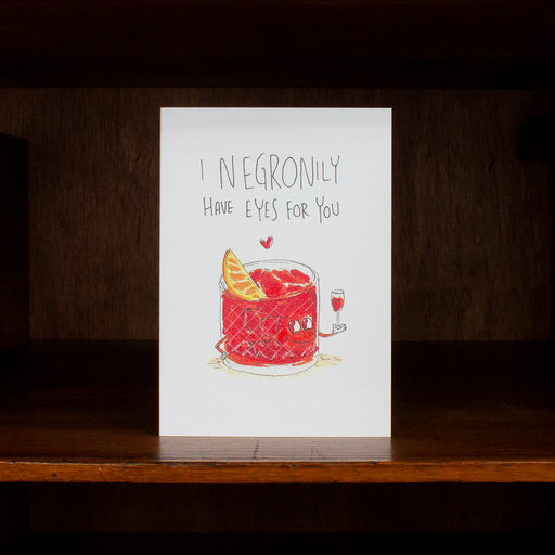 Anniversary and Love greeting card with Negroni illustration and text on a wooden surface