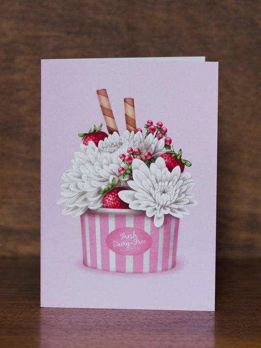 Studio Sue greeting card with a design of flowers and strawberries in a striped container on a wooden surface.
